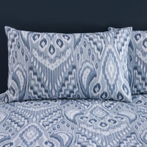 Blue and white patterned bedding set on a dark background