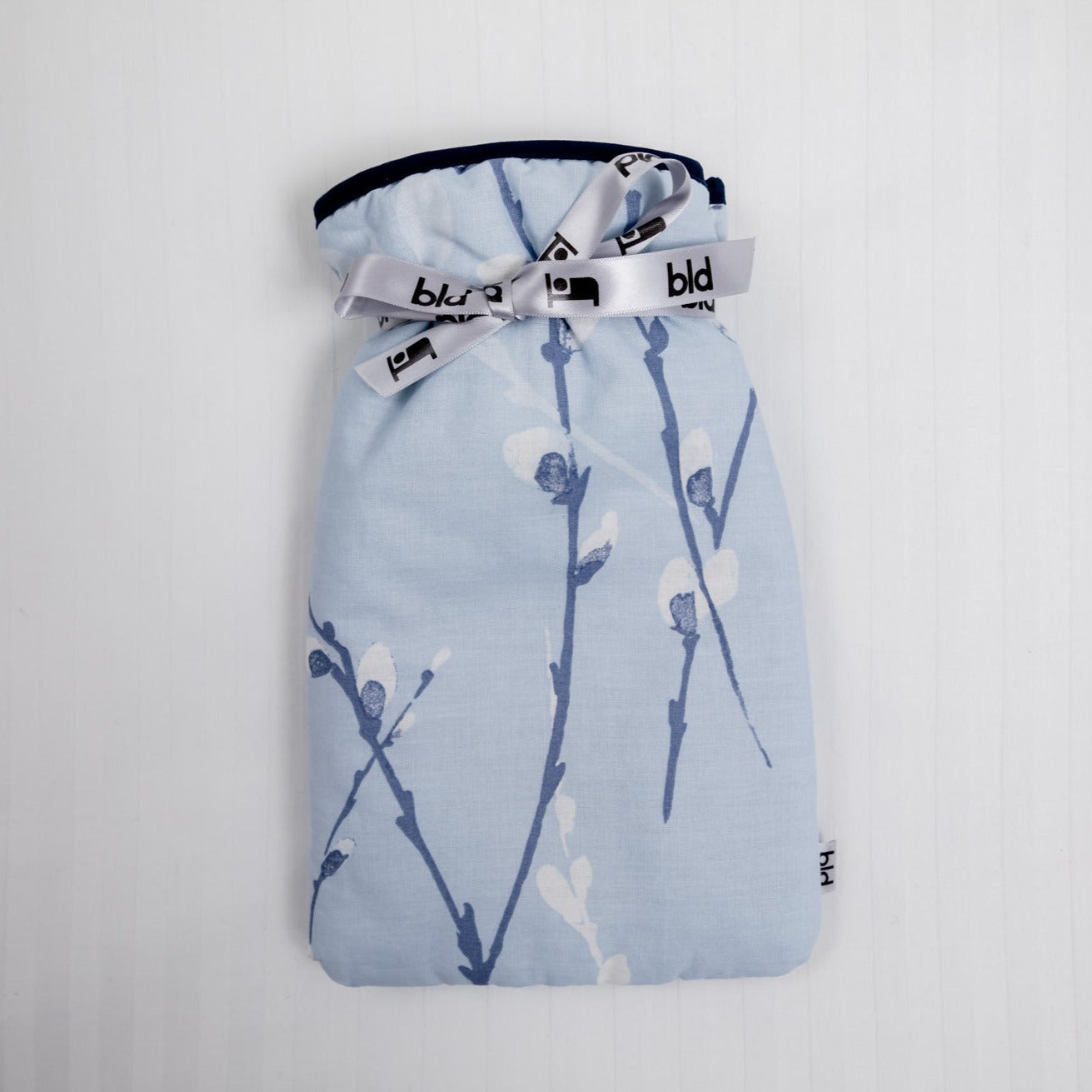Small hot water bottle with blue and white floral soft padded cotton cover