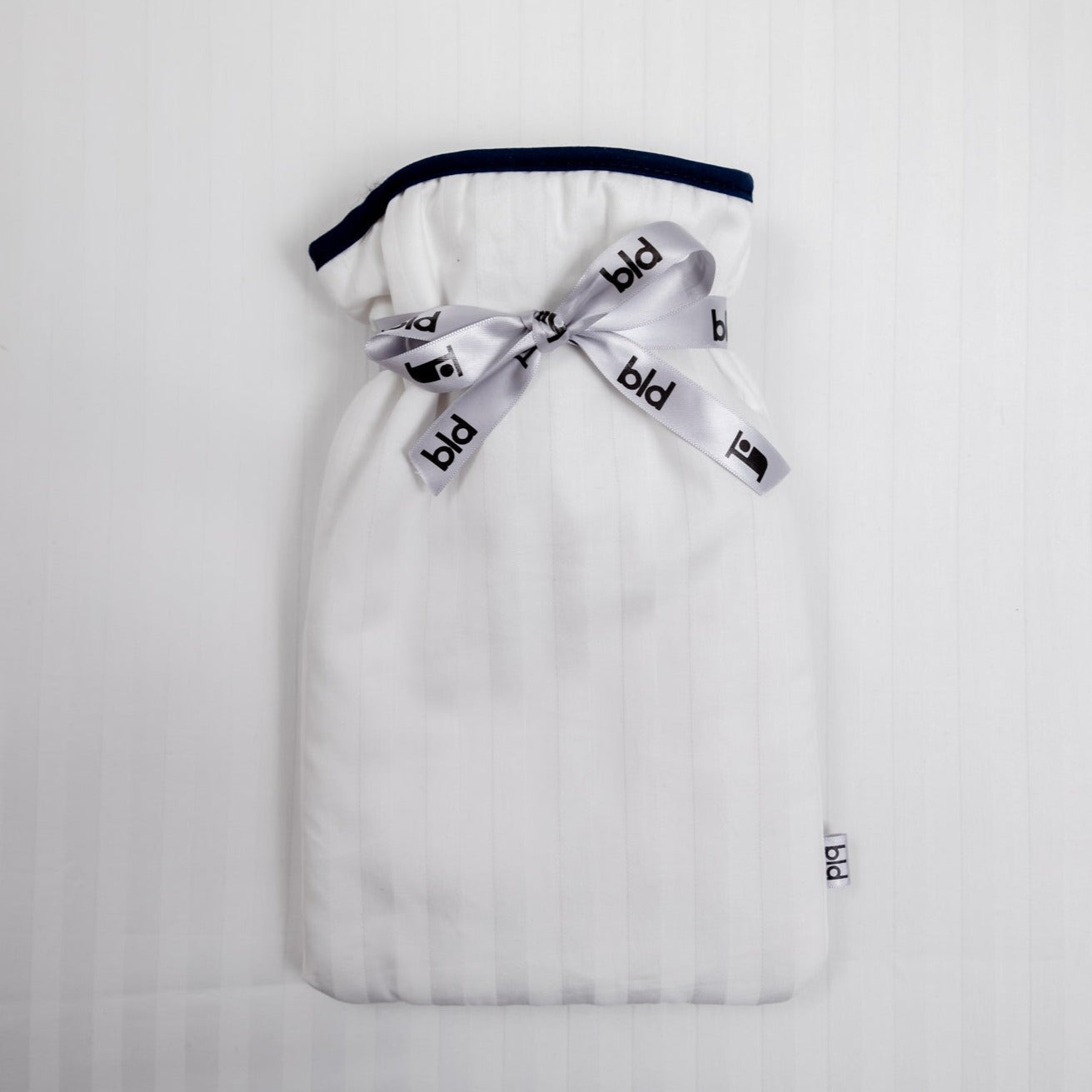 Mini hot water bottle with cosy soft white cover padded